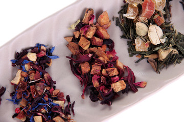 Different kinds of dry tea in dish close up