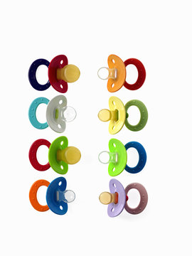 Coloured plastic baby pacifiers, dummies or soothers. 