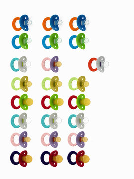 Coloured plastic baby pacifiers, dummies or soothers. 