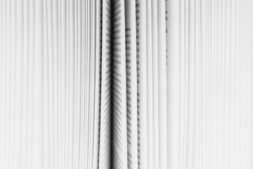 Close up of a book with the pages slightly fanned out, with a black paper edge in the centre. 