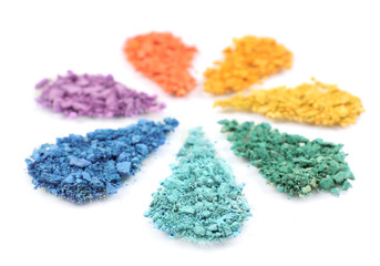 Rainbow crushed eyeshadow in shape of flower isolated on white