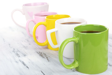 Many cups of coffee on wooden table close up