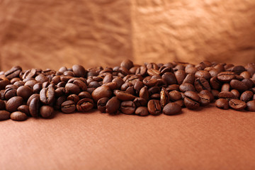 Coffee beans on table on brown background