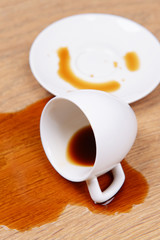 Overturned cup of coffee on floor close-up