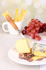 Assorted cheese plate , grape and wine glass