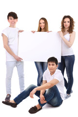 Group of happy young people holding blank poster isolated