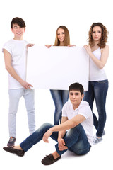 Fototapeta premium Group of happy young people holding blank poster isolated