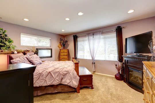 Beautiful bedroom with gentle bedding and window treatment