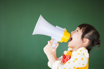 happy child using a megaphone with blackboard