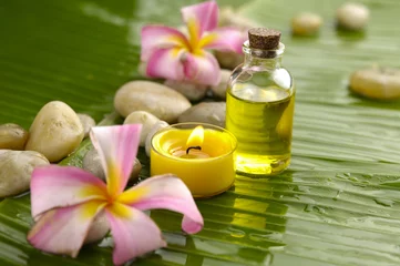 Schilderijen op glas spa with massage oil and two pink orchid,candle on leaf © Mee Ting