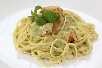 Spaghetti and salmon in pesto sauce