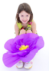 Charming little girl with a huge flower.