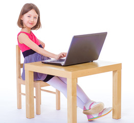  girl sitting at a laptop.