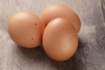 speckled chicken eggs on old table