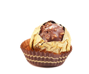 Chocolate gold bonbon with nuts.