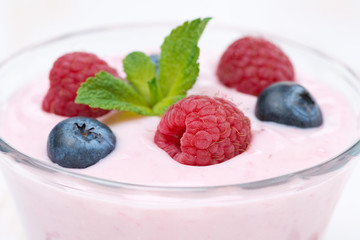 fruit yogurt with raspberry, blueberry and mint, selective focus
