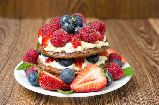 Pancake cake with whipped cream, fresh berries
