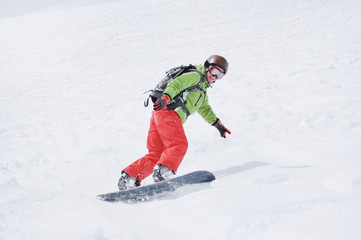 Fototapeta na wymiar Female snowboarder at the mountains