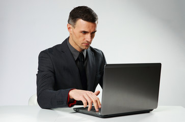 Confident businessman typing on the laptop