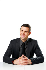 Cheerful businessman sitting at the table 