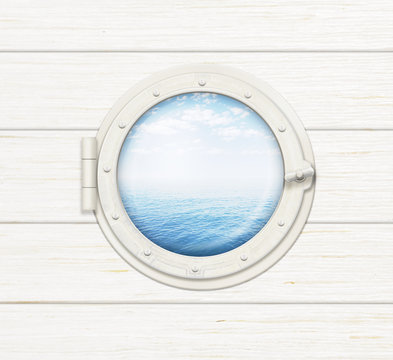 Fototapeta ship window or porthole on wooden wall with sea or ocean visible