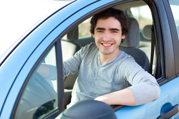 Portrait of an attractive man in his car
