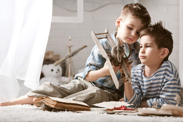 Two boys studying old maps Travel