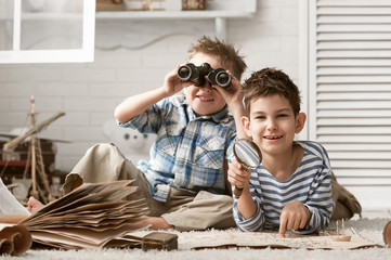 Boys in images traveler studying maps and old books