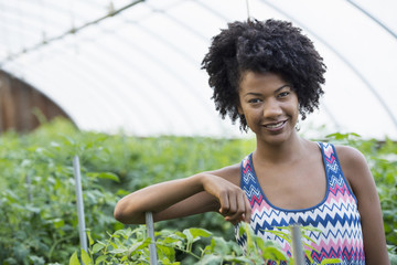 Portrait of  smiling woman in greenhouse