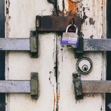 Close up of a padlocked and bolted door. 