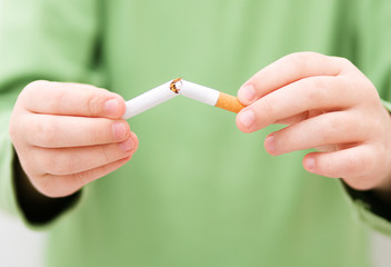 Young girl is breaking a cigarette