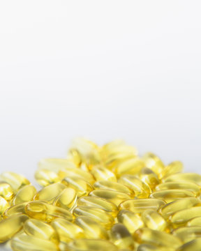 Fish oil providing Omega-3, in softgel supplement capsules. An essential fatty acid and health supplement product. 