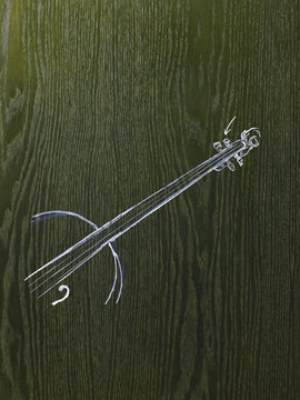 A line drawing image on a natural wood grain background. The neck and strings of a woodwind musical instrument.