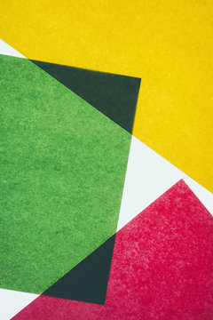 Pieces of colourful, recycled construction paper, overlapping and laid out at random.