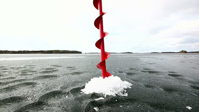 Drilling a hole into weak ice in springtime