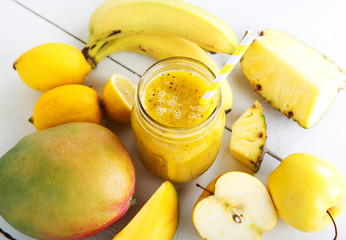 Naklejka na ściany i meble Fresh organic yellow smoothie with banana, apple, mango, pear, p