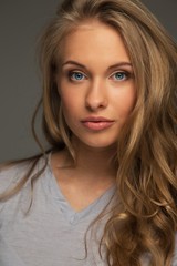 Naklejka premium Positive young woman with long hair and blue eyes