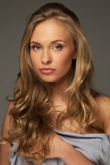 Fototapeta premium Positive young woman with long hair and blue eyes