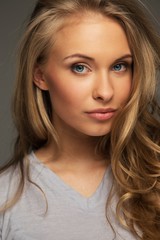 Naklejka premium Positive young woman with long hair and blue eyes
