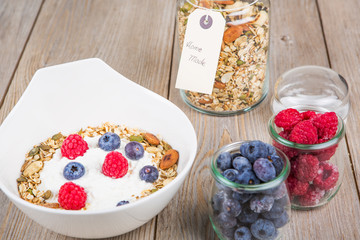 Fresh yoghurt with home made cereals and muesli, fresh raspberry