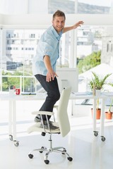 Fototapeta na wymiar Designer surfing on his office chair