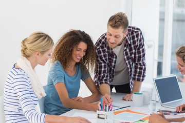 Fototapeta premium Young happy design team brainstorming together