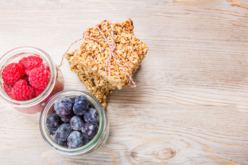 Healthy background: Wooden table with granola cereals bars and s