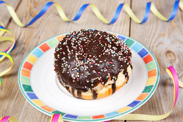 Chocolate and coconut donuts with carnival decoration.