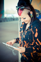 young beautiful punk dark girl using tablet