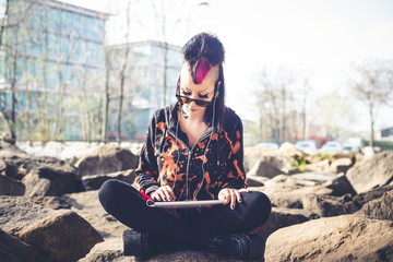 young beautiful punk dark girl using tablet