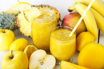 Fresh organic yellow smoothie with banana, apple, mango, pear, p