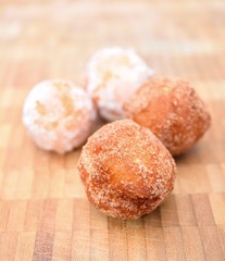 Fresh fried donuts powdered by a sugar.