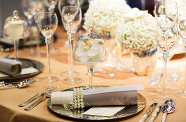 Elegant table set in soft creme for wedding or event party.