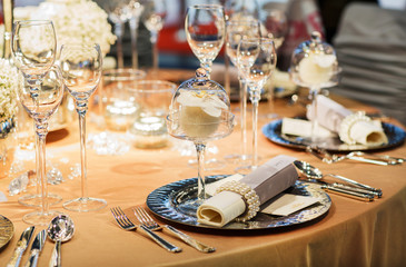 Elegant table set in soft creme for wedding or event party.